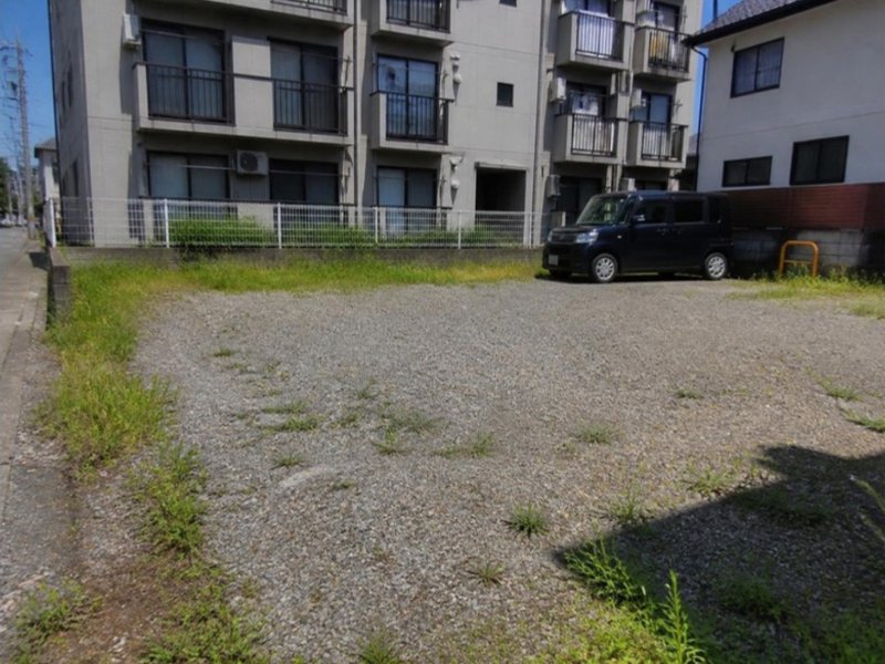 雑草が生えたアパートの駐車場